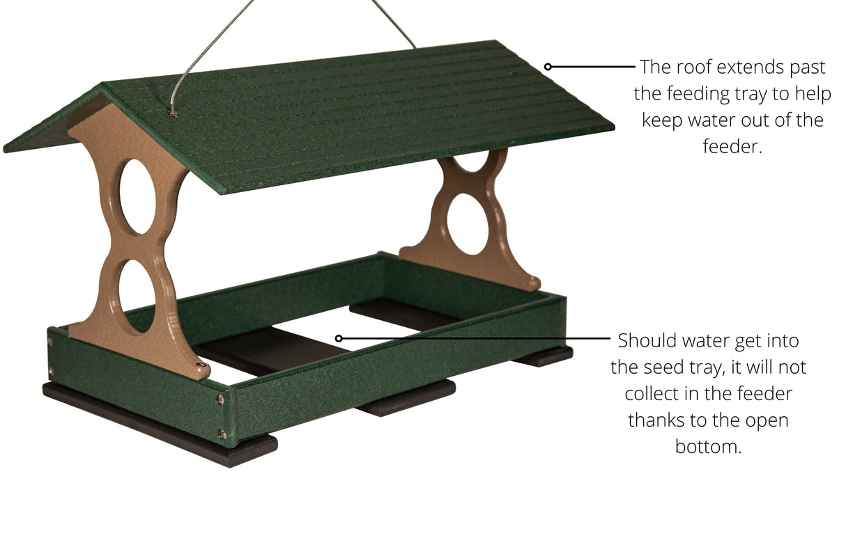 Plastic recycled bird feeder with a dark green roof and tan supports featuring an open bottom and extended overhang for weather protection