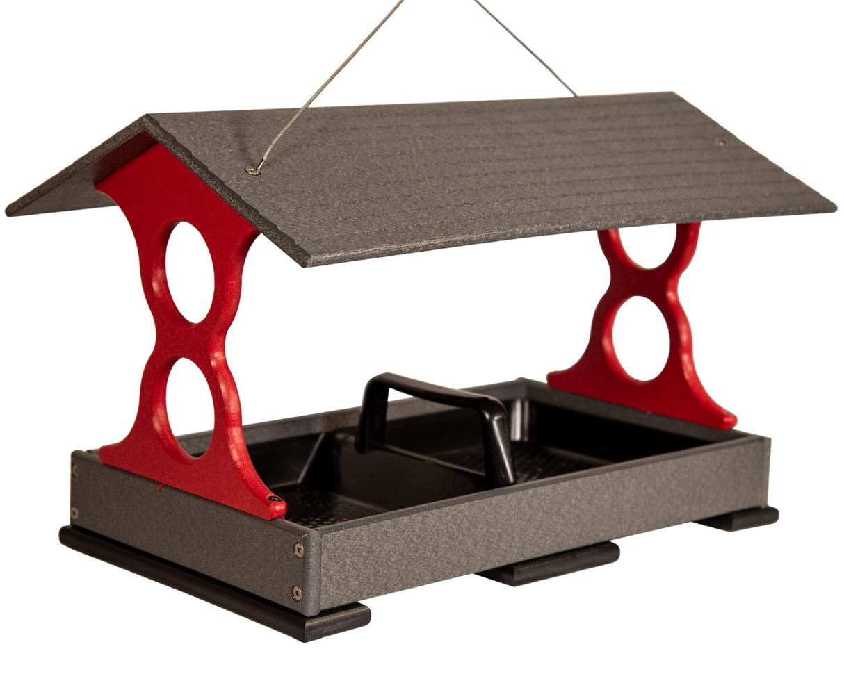 Product Photography recycled plastic bird feeder with a gray roof, red accents and a black tray featuring a convenient carrying handle showcasing its weather-resistant and durable construction
