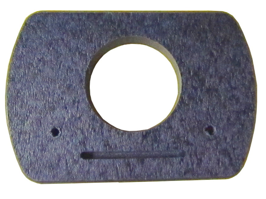 Close-up of a dark purple rectangular object with a central hole two small holes and a long thin groove showing a textured surface