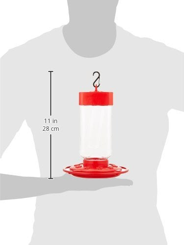 Product shot showing a red and clear plastic hummingbird feeder with a metal hook against a grey background, the feeder features a cylindrical reservoir and a wide red base for stability