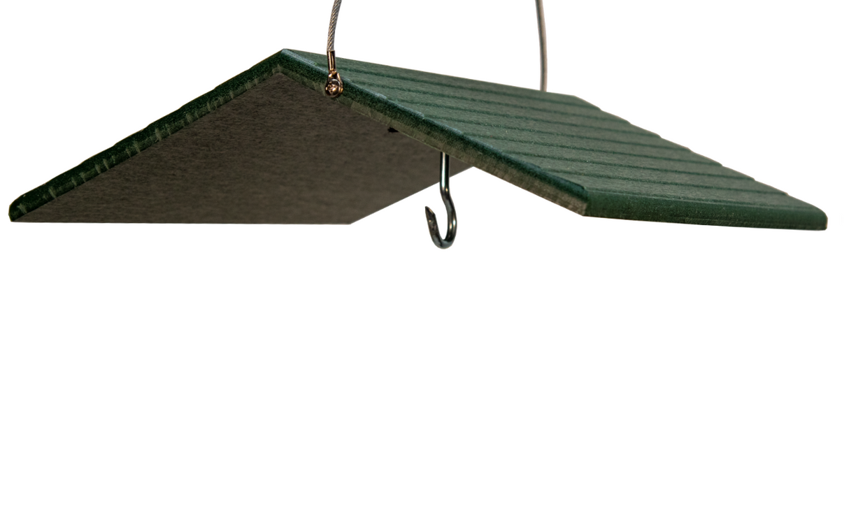Product shot of a dark green plastic bird feeder with a pitched roof, featuring a metal hook and wire hanger, showing ribbed texture and subtle metallic accents