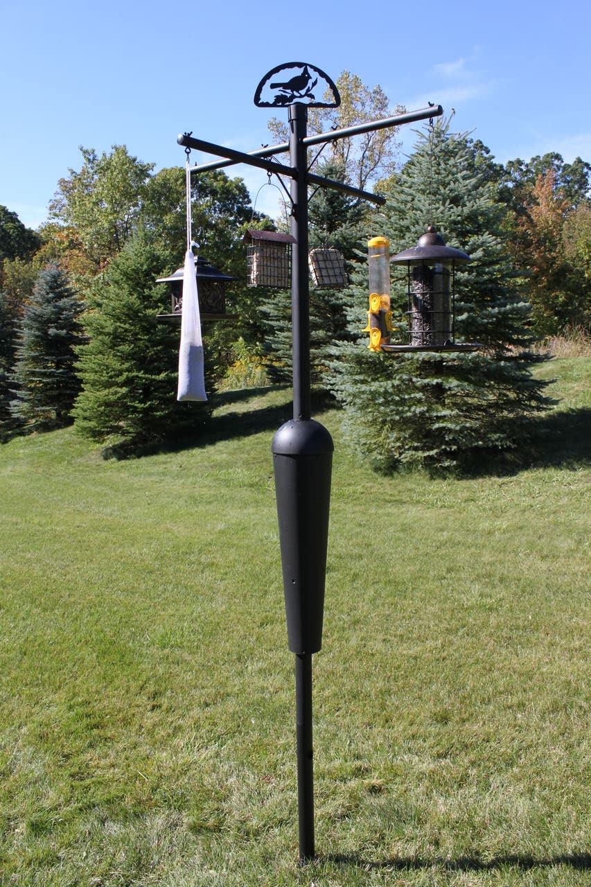 Squirrel Stopper Black Deluxe Squirrel Proof Pole System with Baffle setup in garden, featuring bird feeders and aesthetic design.