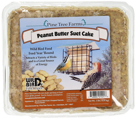 Pine Tree Farms peanut butter suet cake package showing a red-bellied woodpecker and a  brown creeper at a bird feeder with scattered peanuts and a rich, speckled, brown-beige texture.