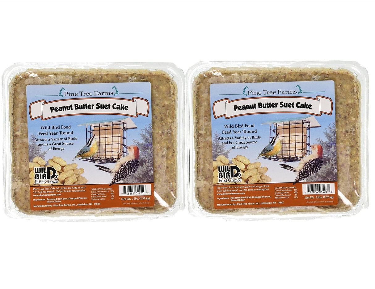 Pine Tree Farms peanut butter suet cake packaging shows two cakes, a bird feeder, a downy woodpecker, a chickadee, and showcases rich brown and beige tones with a teal label