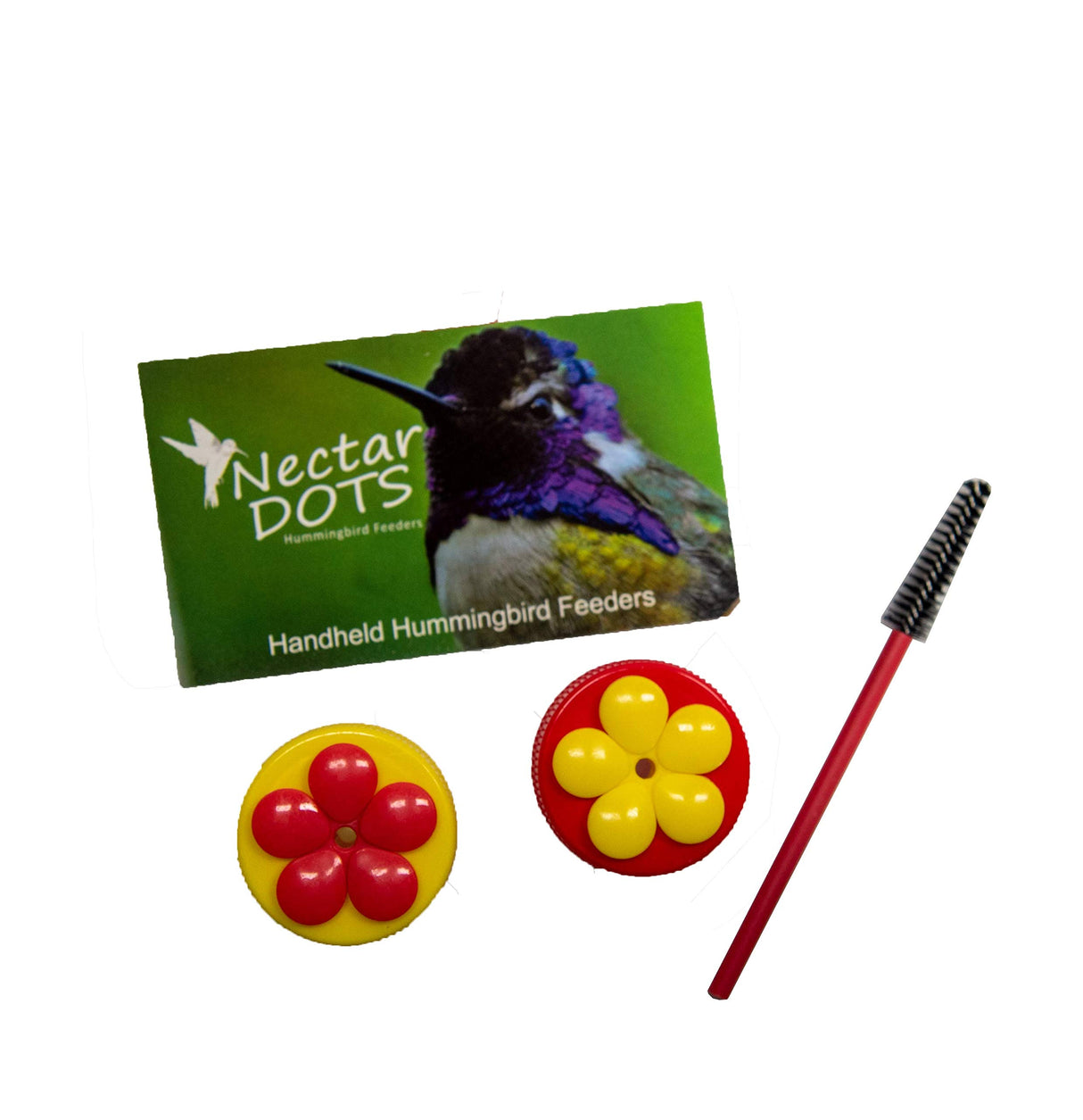 Product shot showing two red and yellow Nectar Dots handheld hummingbird feeders a red cleaning brush and  packaging featuring a hummingbird with iridescent purple and green feathers