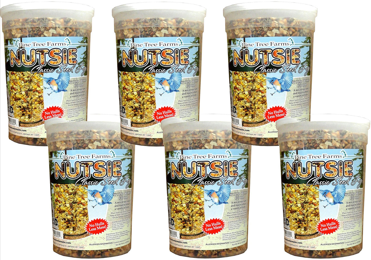 Pine Tree Farms Nutsie Classic Seed Log six-pack showing a vibrant mix of tree nuts, seeds, and dried fruit with a cheerful bluebird and a  prominent No Hulls Less Mess! label