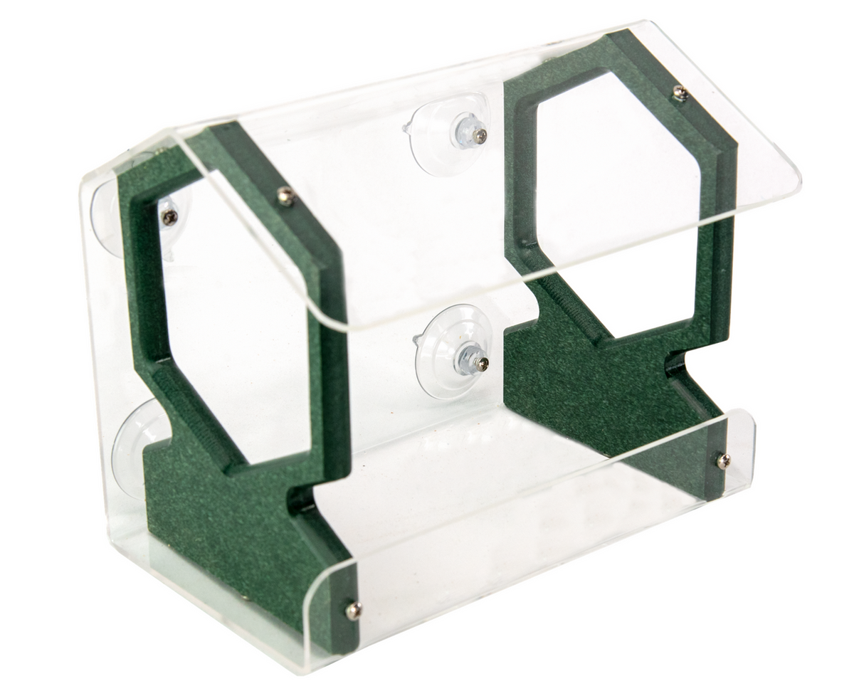 Product shot of an acrylic and recycled plastic bird feeder featuring a clear body dark green accents and suction cups for window mounting