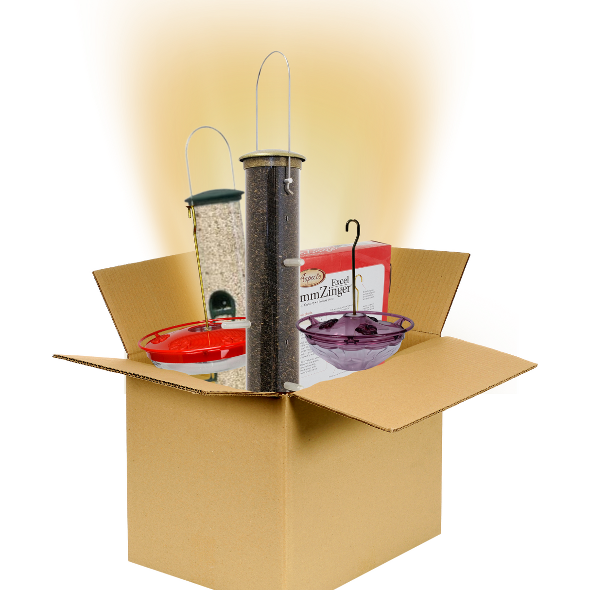 Product shot showing a cardboard box containing three bird feeders a red Aspects hummingbird feeder a tall clear tube feeder and a purple glass feeder along with a box of Aspects Excel mmZinger birdseed in a studio setting