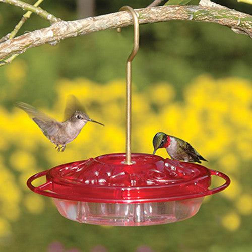 Two hummingbirds feeding from the Aspects 382 HummZinger Little Fancy Feeder in a colorful garden setting.