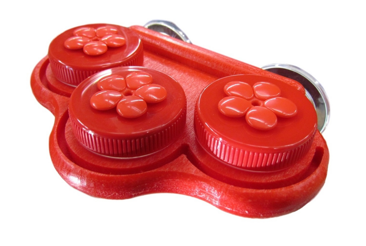 Plastic red double-container with flower-shaped lids and suction cups showcasing vibrant glossy finish and textured detailing