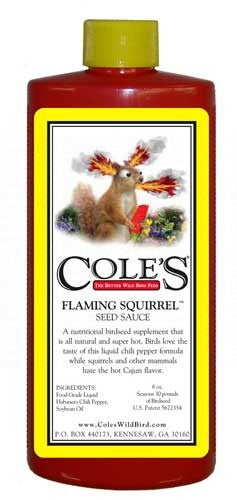 Product label illustration of Coles Flaming Squirrel Seed Sauce featuring a cartoon squirrel engulfed in flames holding a red pepper against a yellow and white background
