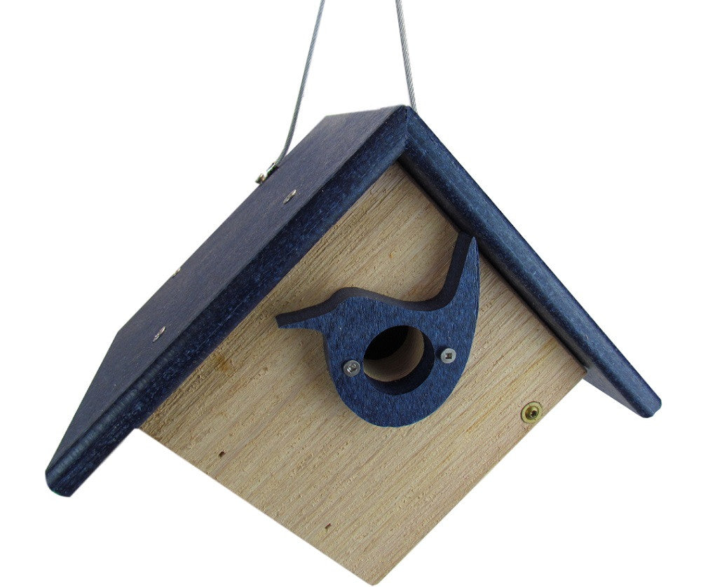 Wooden birdhouse with a dark blue roof and bird-shaped entrance hole hanging against a white background featuring a natural wood body and brass screws