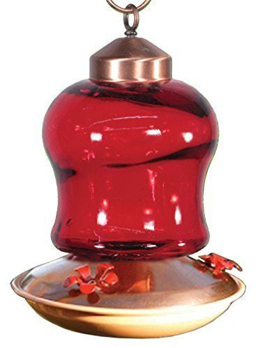 Glass hummingbird feeder with copper accents showing a vibrant red glass reservoir and red feeding ports against a white background