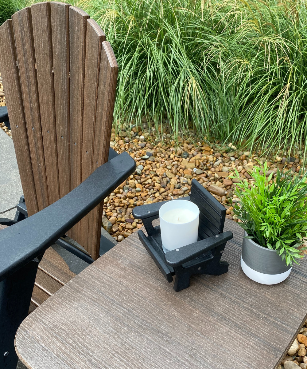 JCS Wildlife Mini White Adirondack Chair Candle Holder with candle on outdoor table, perfect for lake life.