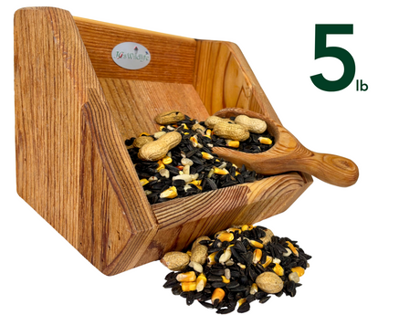 JQsWildlife wooden bird feeder overflowing with a five pound mix of black oil sunflower seeds corn and peanuts in a rustic setting