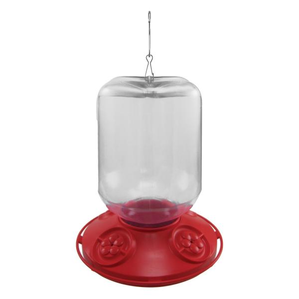 Plastic hummingbird feeder with a clear reservoir a red base and four flower-shaped feeding ports featuring a silver hanging hook