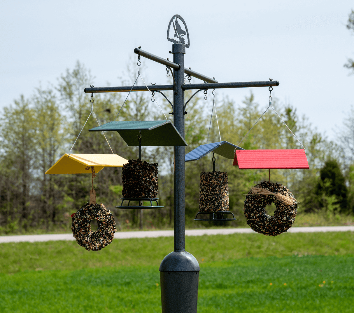 JCS Wildlife Large Poly Weather Cover above colorful bird feeders for protection against rain and snow.