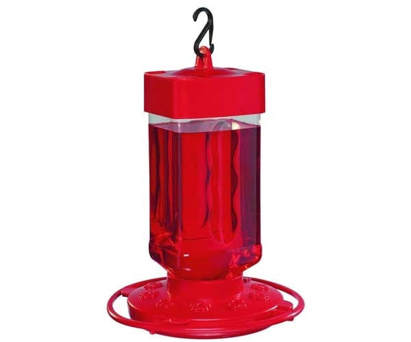 Plastic hummingbird feeder with bright red body, clear reservoir filled with red nectar, and a small black hook for hanging