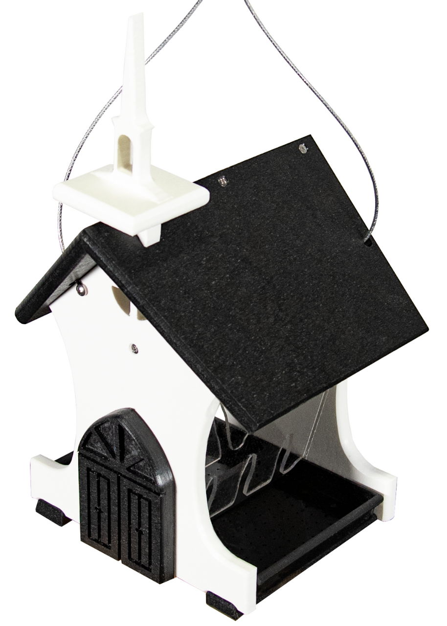 Plastic bird feeder shaped like a church with a steeple, dark gray roof, and white walls featuring a black door and perches for birds.