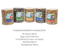 Product shot showing five cylindrical containers of Wild Bird Blend birdseed including All Season Blend Bugs Nuts Berries Fruit Blend and Woodpecker Blend each with colorful labels and images of birds