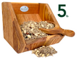 JCs Wildlife product photography shows a wooden bird feeder filled with a 5lb mix of sunflower seeds peanuts and raisins a rustic wooden scoop rests beside the feeder showcasing the rich wood grain and the colorful birdseed mix