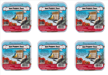 Pine Tree Farms product image showing six packages of Hot Pepper Suet wild bird food, featuring a yellow bird, a red-headed woodpecker, and a cage-style bird feeder, with vibrant red peppers and a blue and yellow label design