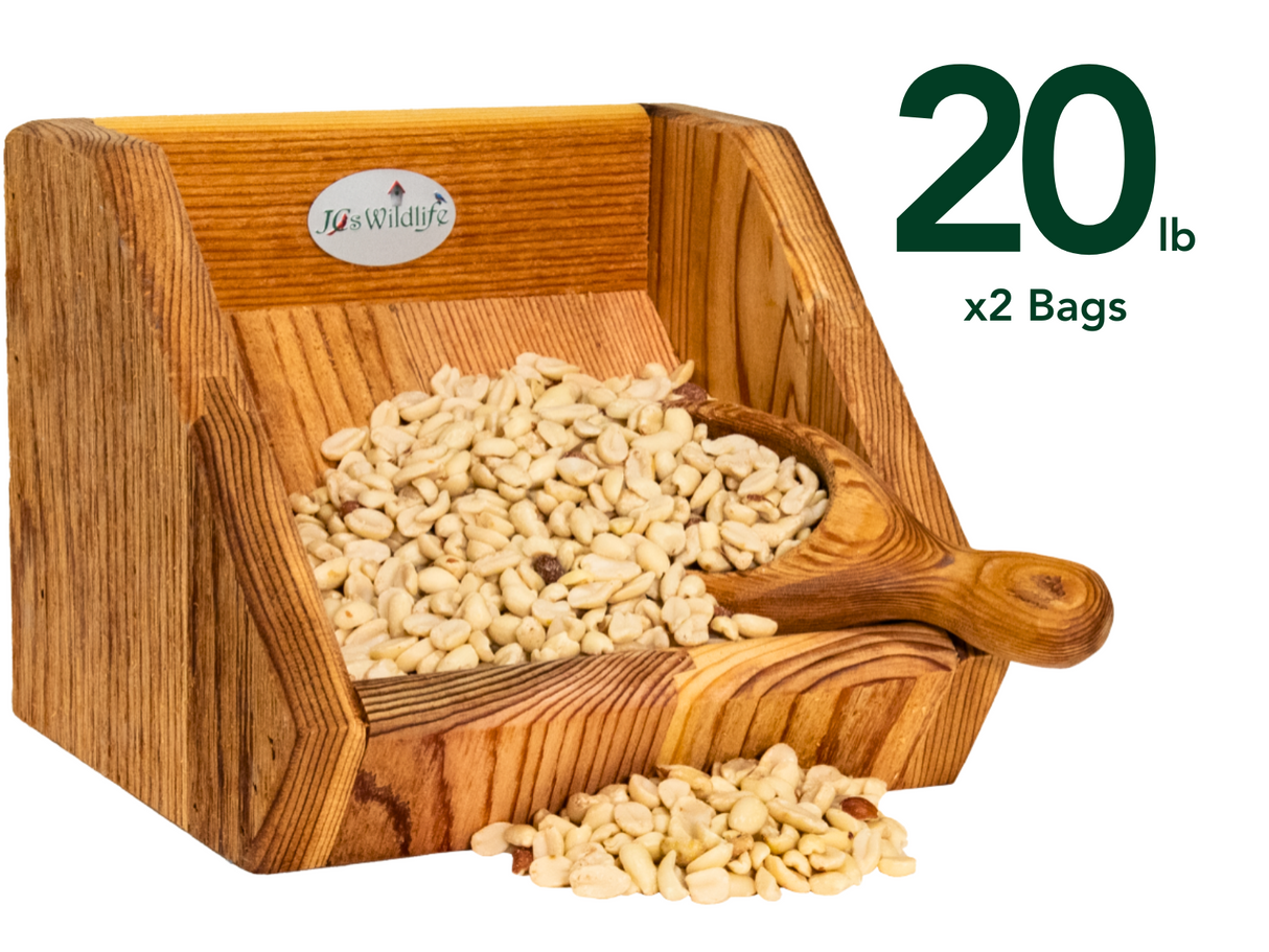 JCs Wildlife wooden peanut feeder overflowing with creamy-white peanuts and a rustic wooden scoop showing rich wood grain and a JCs Wildlife logo
