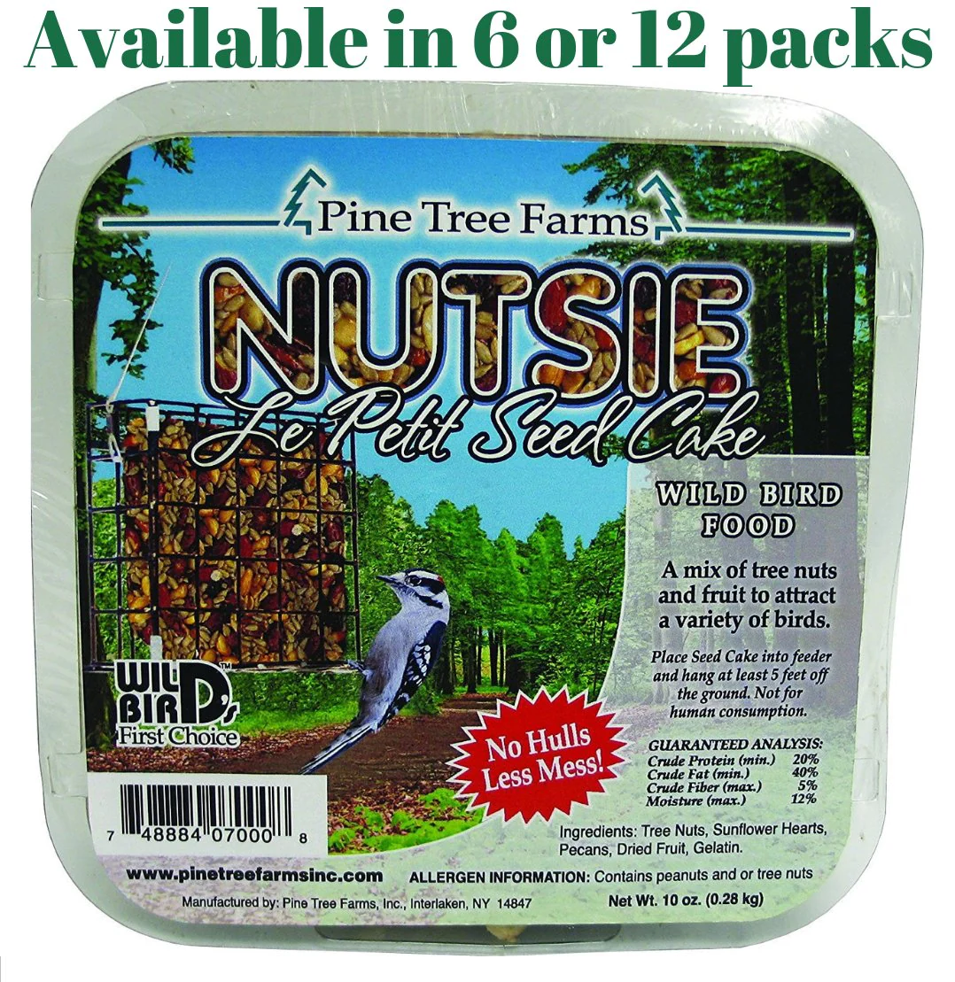 Pine Tree Farms Nutsie Le Petit Seed Cake package showing a downy woodpecker at a bird feeder in a lush green forest with vibrant red and orange seeds and nuts