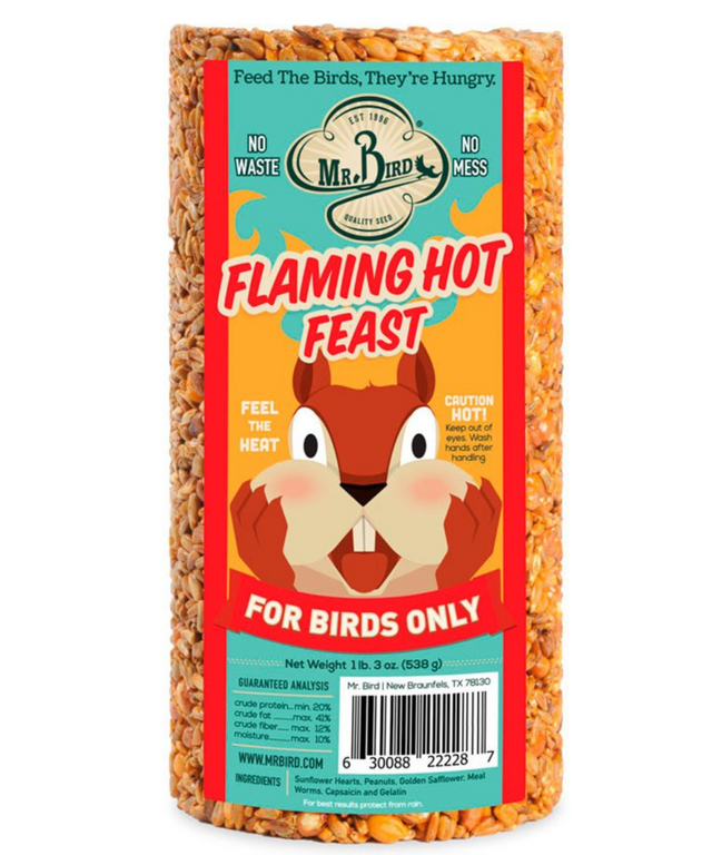 Mr Bird product photography showing a Flaming Hot Feast bird food log featuring a cartoon squirrel on a red and orange label with sunflower seeds peanuts and worms