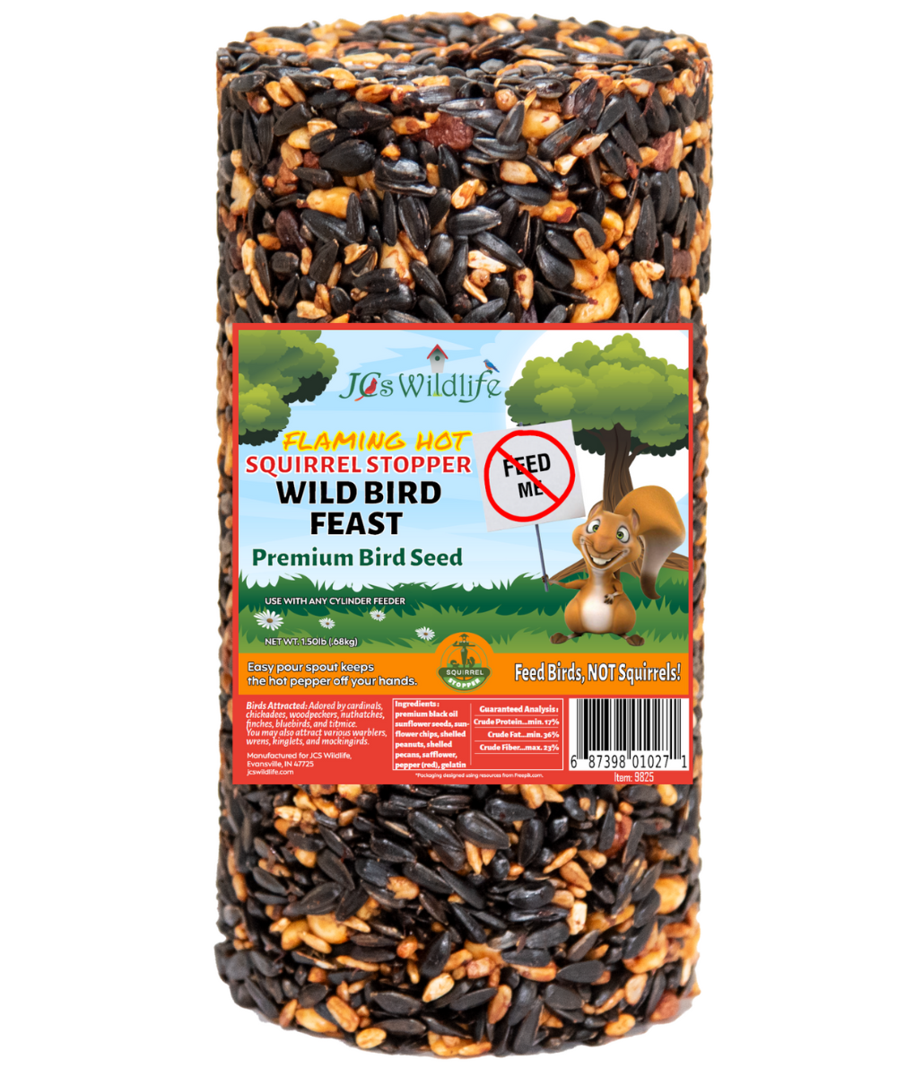 JCs Wildlife Flaming Hot Squirrel Stopper Wild Bird Feast premium bird seed cylinder showing sunflower seeds, peanuts, and red pepper flakes against a cartoon squirrel backdrop.