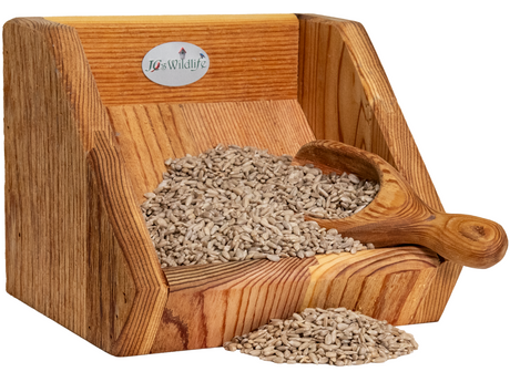 JCS Wildlife 5 Pound Sunflower Chips in a wooden feeder, showcasing bird seed for wild birds.