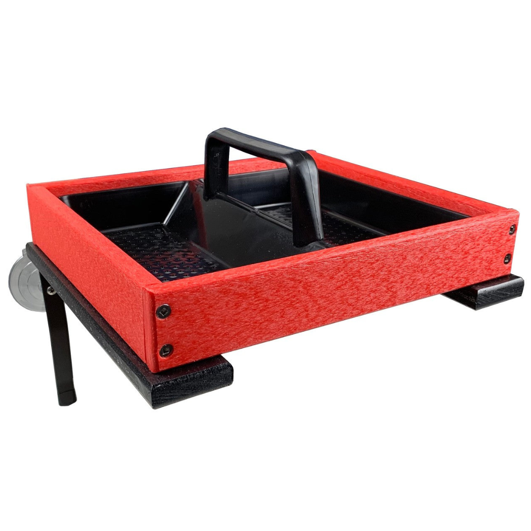 Product shot of a red and black plastic bird feeder with a built-in handle and suction cup mount showing textured surface, visible screws and a perforated inner tray