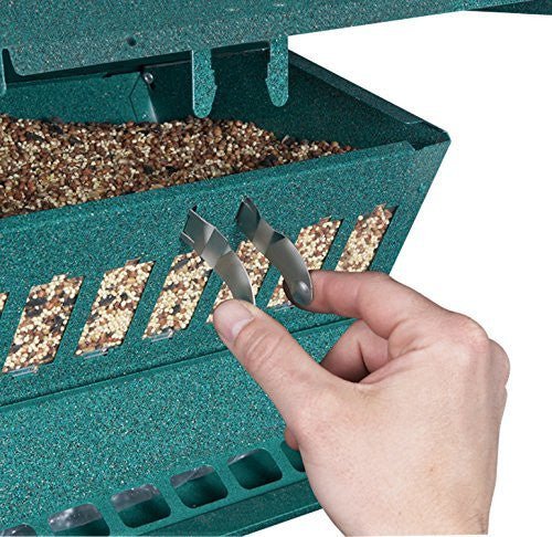 Hand adjusting counter balance perches on Absolute II Squirrel-Proof Bird Feeder by Green Heritage Farms.