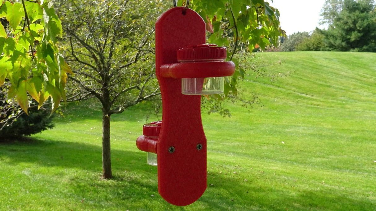 Double Hanging Nectar DOTS with bright red poly lumber holder and 4 large jars, perfect for attracting hummingbirds, hanging outdoors.