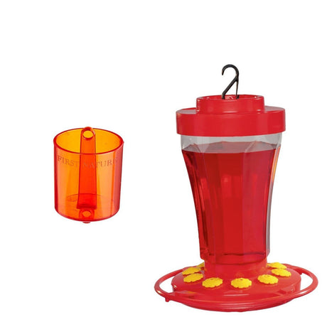 First Nature 3090 Hummingbird Nectar Flower Feeder with First Nature 3306 Ant Barrier in red, featuring yellow flowers and a wide-mouth design.