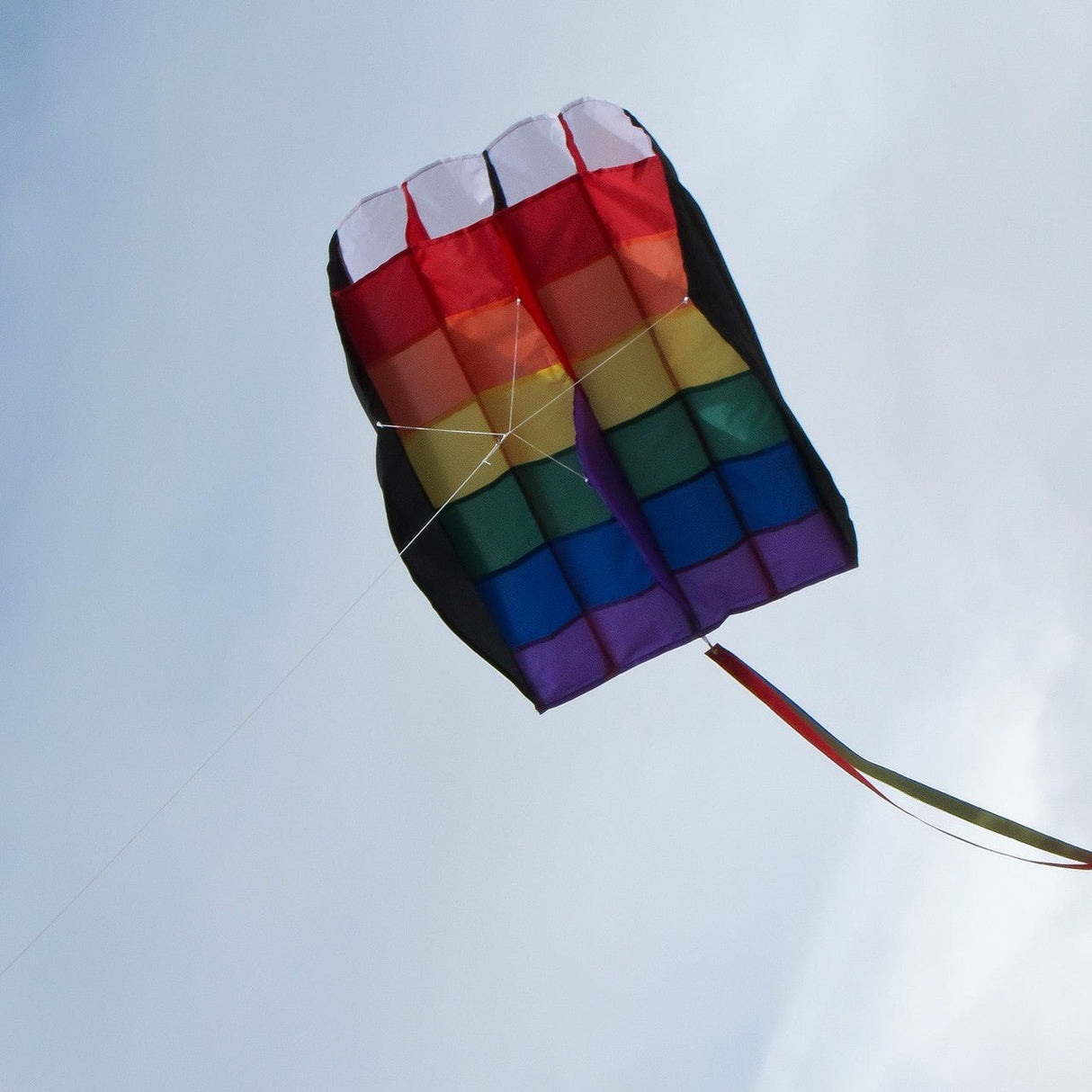 In the Breeze 5.0 Rainbow Stripes Air Foil Kite flying in the sky with its vibrant colors and aerodynamic cell structure.