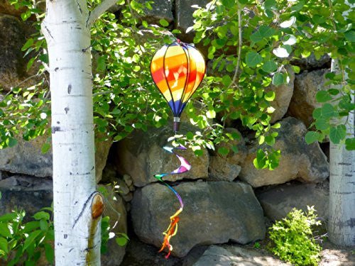 Unknown artist fabric hot air balloon garden spinner amongst aspen trees and large rocks showing vibrant orange yellow and purple hues