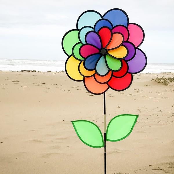 In The Breeze 24-Petal Flower Triple Wheel Spinner with Leaves in bright colors at the beach.
