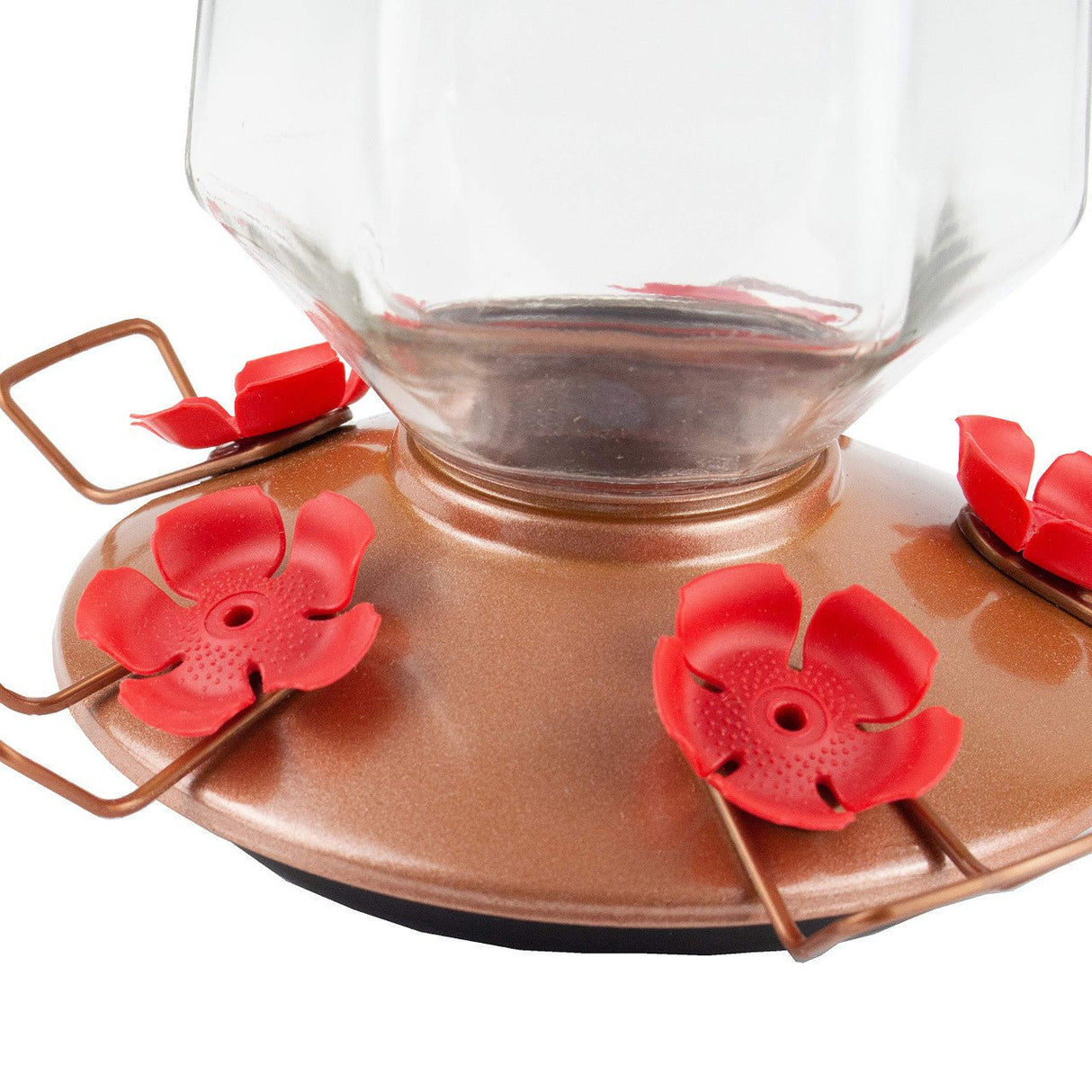 Close-up of Perky-Pet Crystal Top-Fill Glass Hummingbird Feeder with red flower feeding ports and bronze base holding 28 oz of nectar.