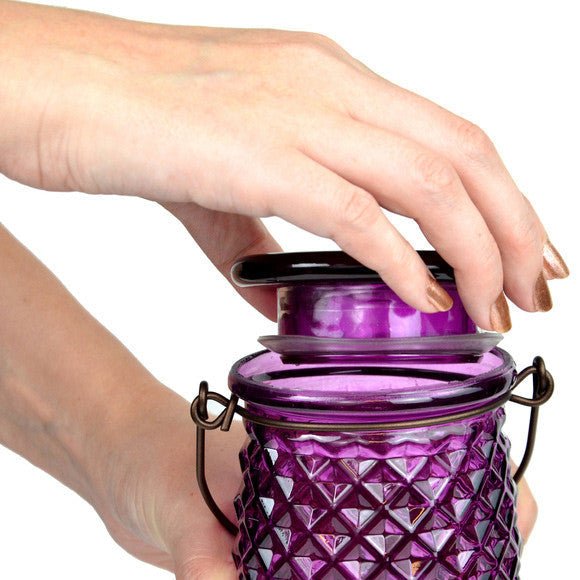 Filling the Perky-Pet Diamond Wine Top-Fill Glass Hummingbird Feeder with wide-mouth opening, easy and mess-free design