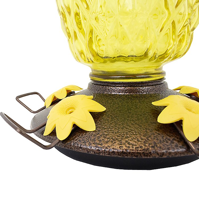 Close-up of Perky-Pet Pineapple Top-Fill Hummingbird Feeder's base with yellow flower feeding ports.