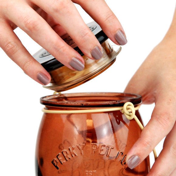 Person filling Perky-Pet Sugar Maple Top-Fill Glass Hummingbird Feeder with nectar