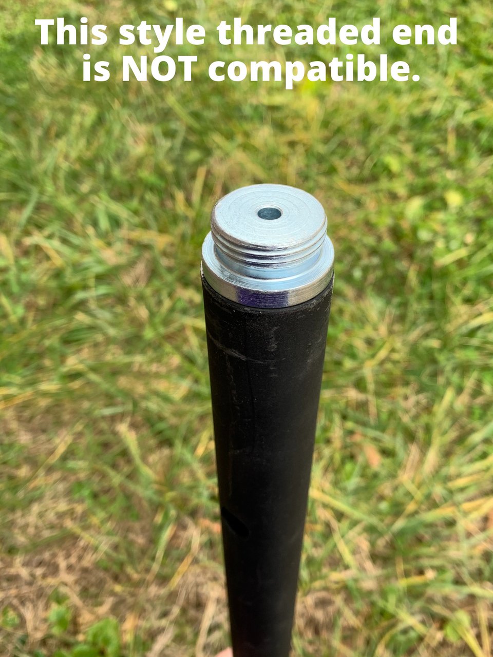 Squirrel Stopper Pole Extender with incompatible threaded end shown against grass background