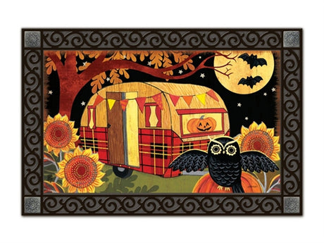 Studio M Halloween Camper MatMate doormat featuring a camper, owl on a pumpkin, bats in the sky, and sunflowers in festive orange, black, and white.