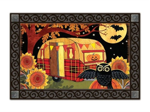 Halloween camper doormat with owl on pumpkin and bats in sky, sunflowers in corner. Festive orange, black, and white colors. Recycled rubber backing.