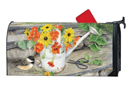 Studio M Sunshine and Water MailWrap mailbox cover featuring a watering can with flowers, a perched bird, and gardening shears.