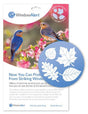 WindowAlert product image showing two vibrant bluebirds perched on a flowering branch with pink blossoms, featuring a circular decal of four white leaf silhouettes against a blue background, including oak and maple leaves.