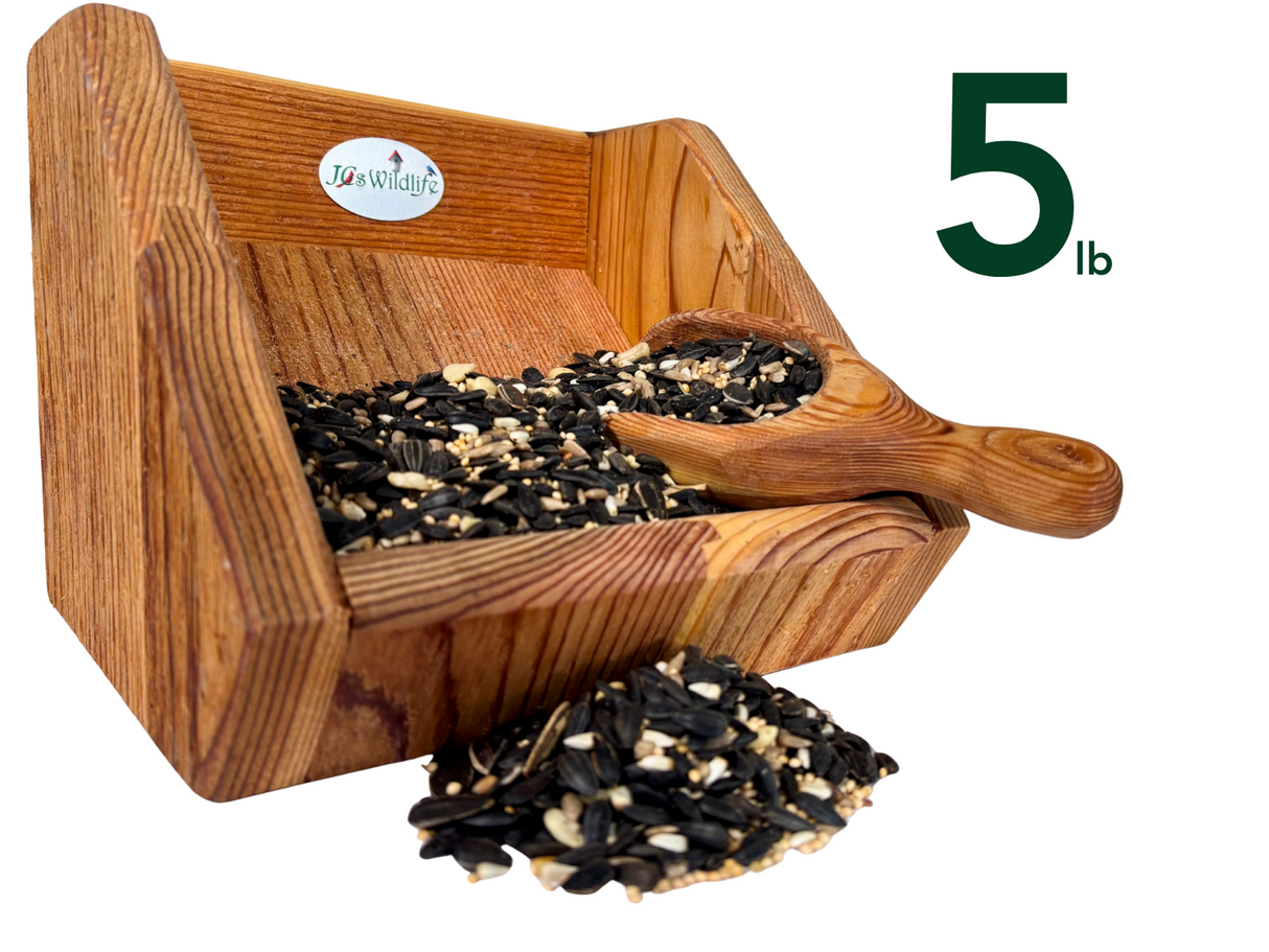 JQs Wildlife wooden bird feeder filled with 5 pounds of mixed birdseed including sunflower seeds millet and cracked corn displayed with a wooden scoop
