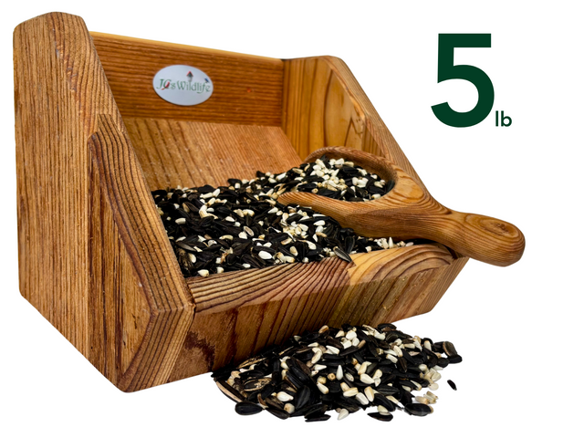 JQsWildlife wooden bird feeder filled with five pounds of black oil sunflower seeds white striped sunflower seeds and nyjer seeds showing rich wood grain and a small wooden scoop
