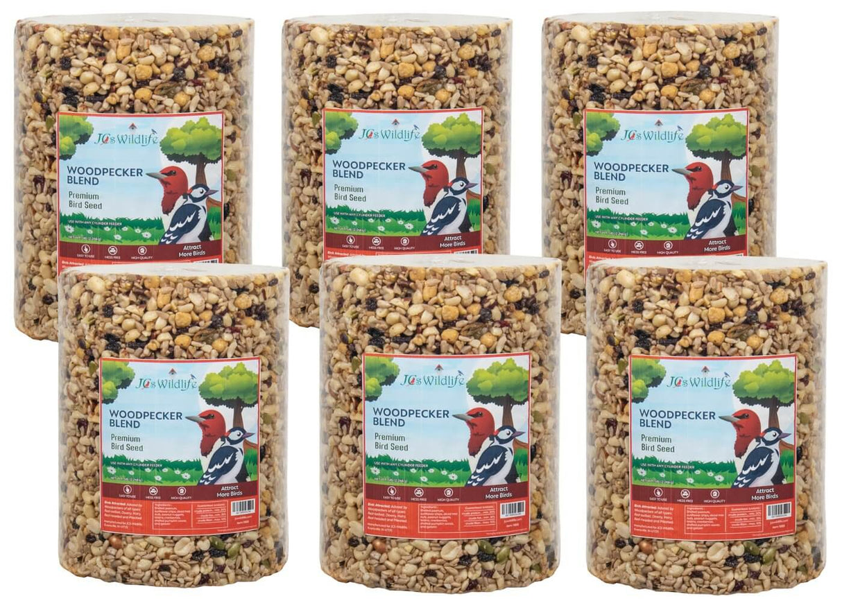 Six JCS Wildlife Woodpecker Blend Bird Seed Large Cylinders, 5 lb each, featuring high-quality nuts, seeds, fruits, and berries.